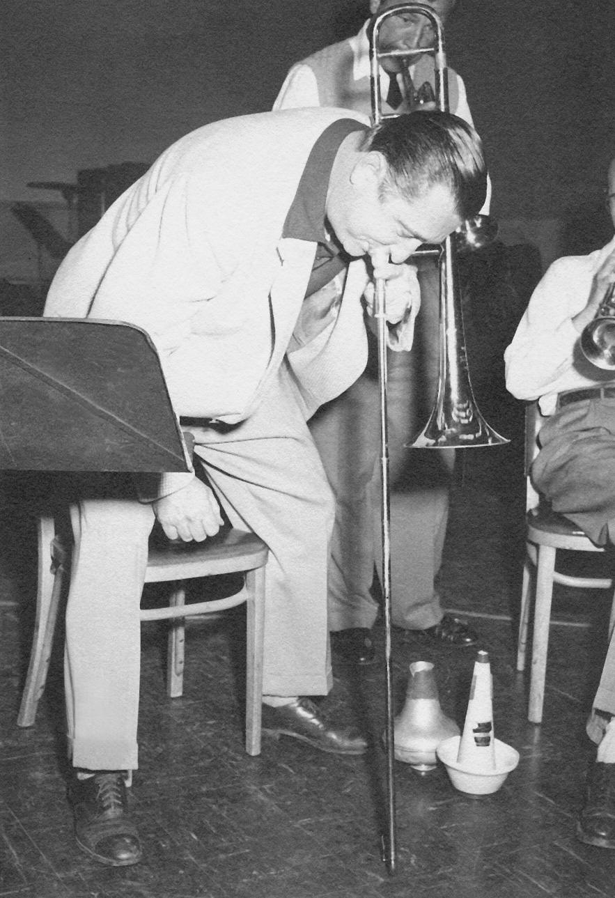 Abe playing horn w/slide on floor